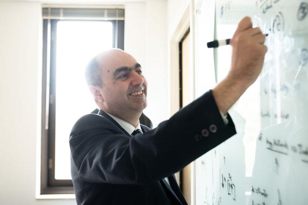 Professor writing on white board